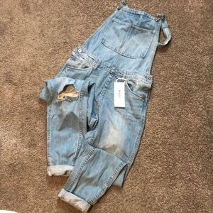 Distressed denim overalls